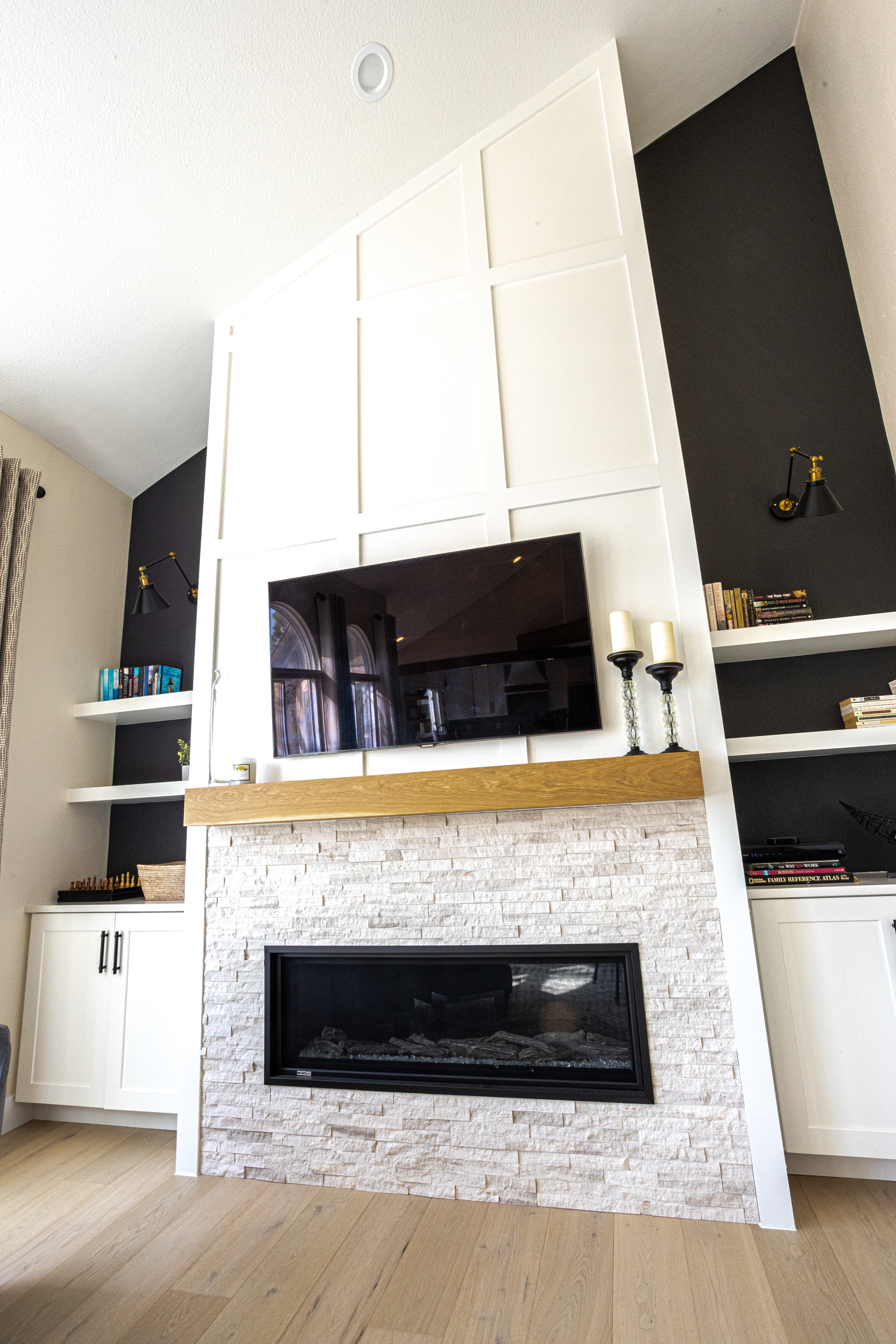  Living room with TV and fireplace above built-ins